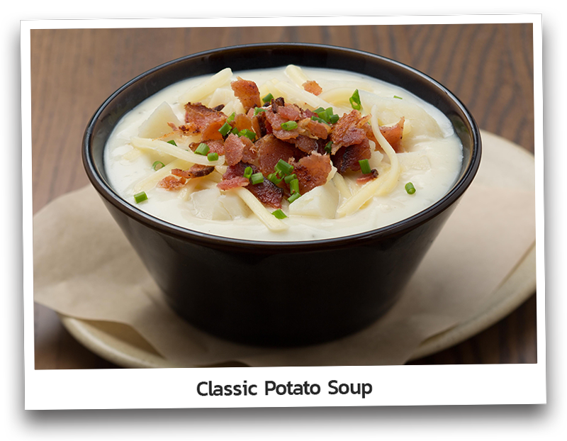 Picture the classic potato soup topped with cheddar cheese, bacon and chives and presented on a small bowl.