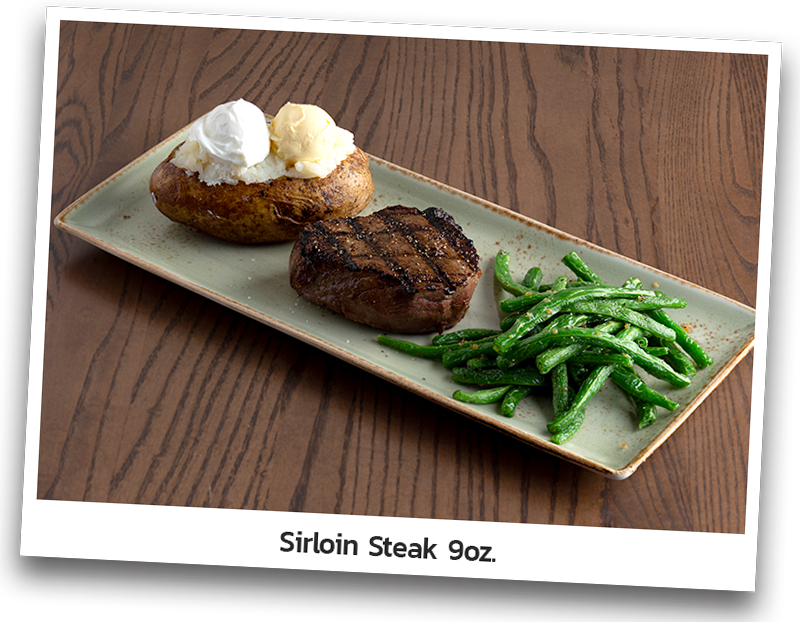 Seasoned and grilled sirloin steak served with baked potato and seared green beans and presented on a rectangle plate.