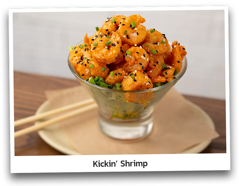 Crispy shrimp tossed in spicy cream sauce. Topped with sesame seeds and chives, presented on a glass bowl and served with chopsticks.
